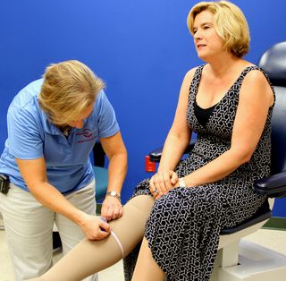 A lymphedema therapist measures the leg of Amy Caterina, of San Diego, Calif., prior to surgery for lymphedema.