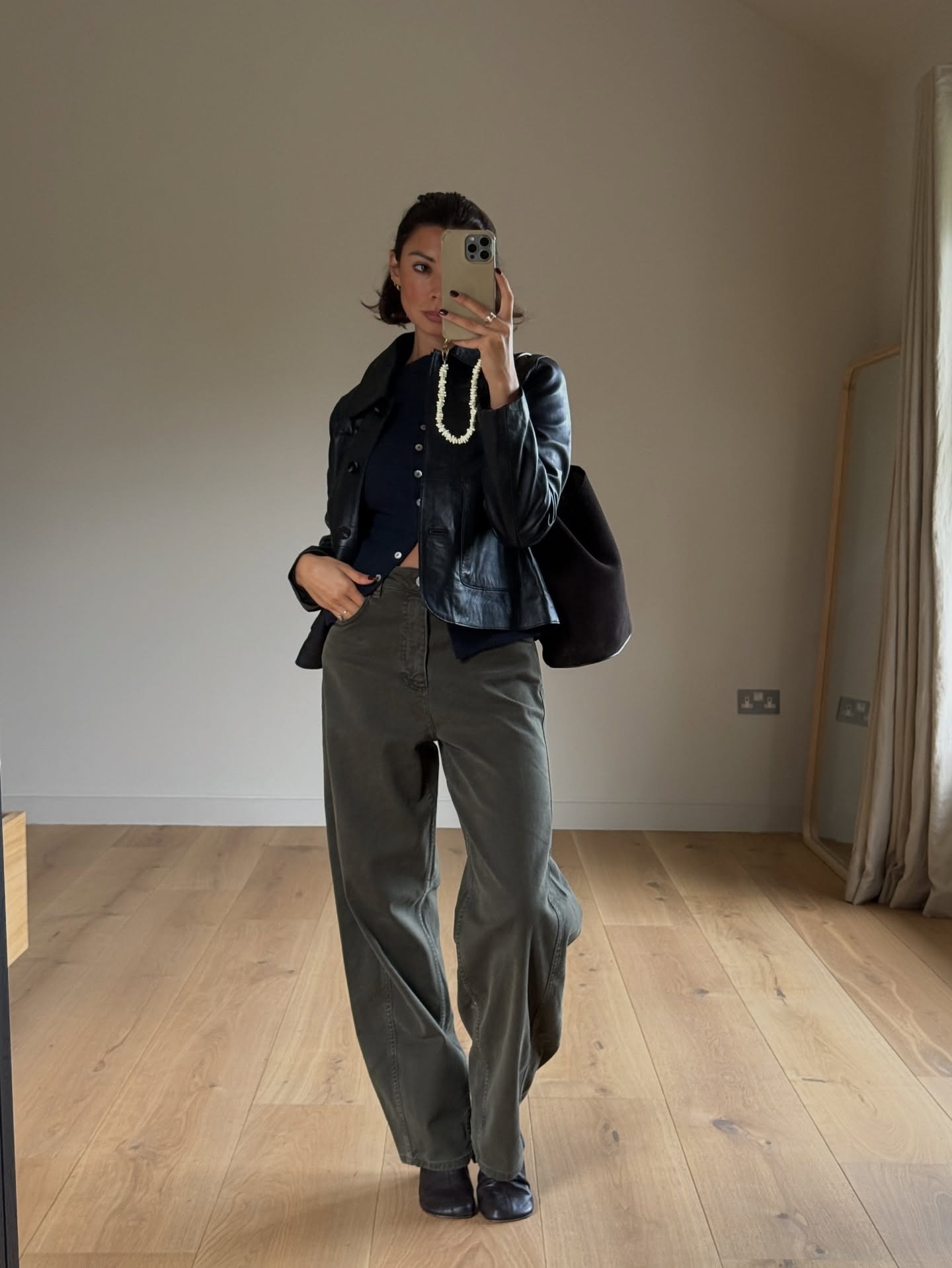 Woman wearing fall outfit with black ankle boots.