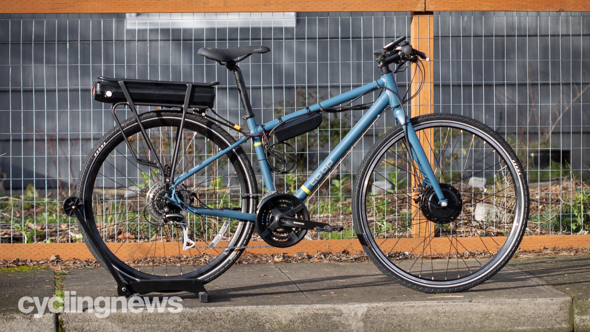 Bafang front wheel conversion kit fitted to a blue hybrid bike