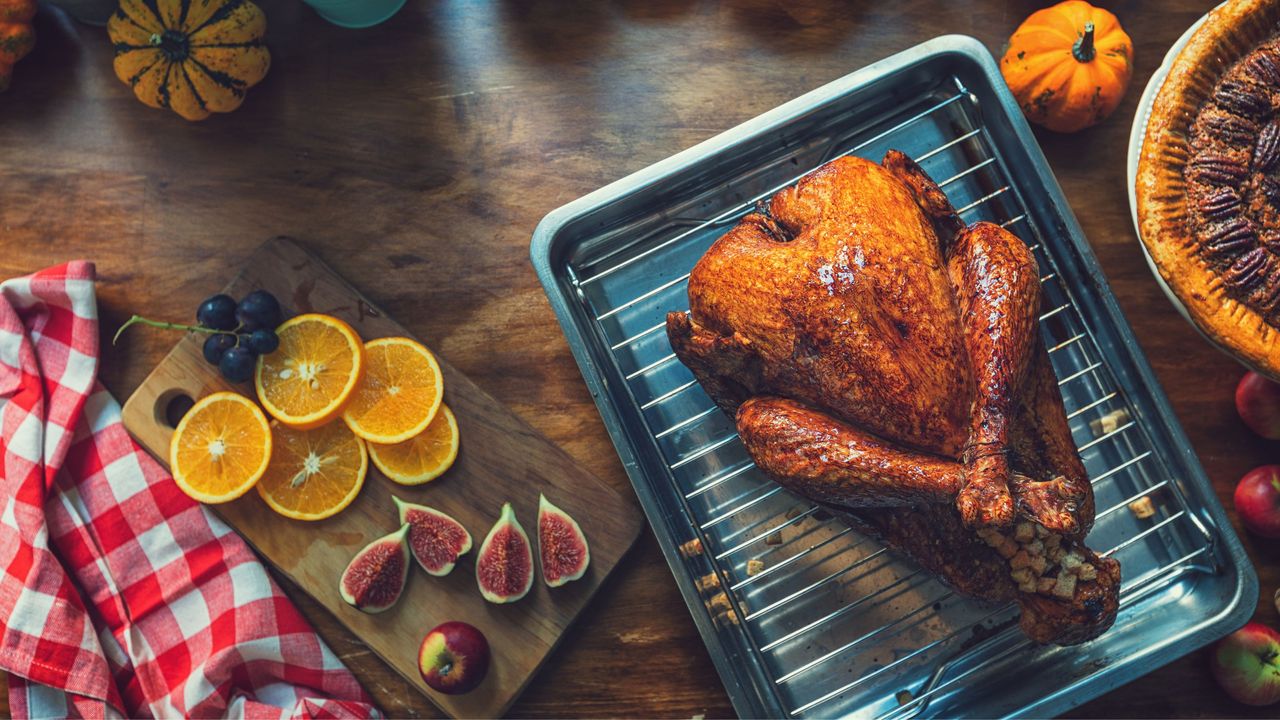 Turkey roasting pan next to a chopping board with fruits