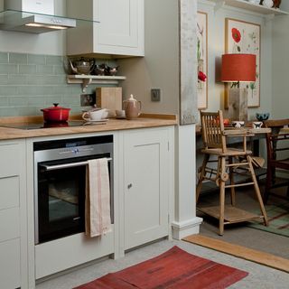 kitchen with electric stove and white cabinet