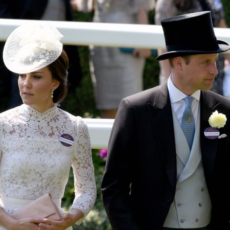 Kate Middleton wears a white lace dress with a matching hat and Prince William wears a top hat and tails