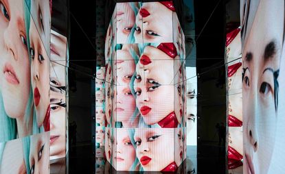 Image of woman's face wearing lipstick as installation view of ‘Re-Signify Part II' exhibition