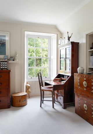 wooden writing desk with chairs in living room