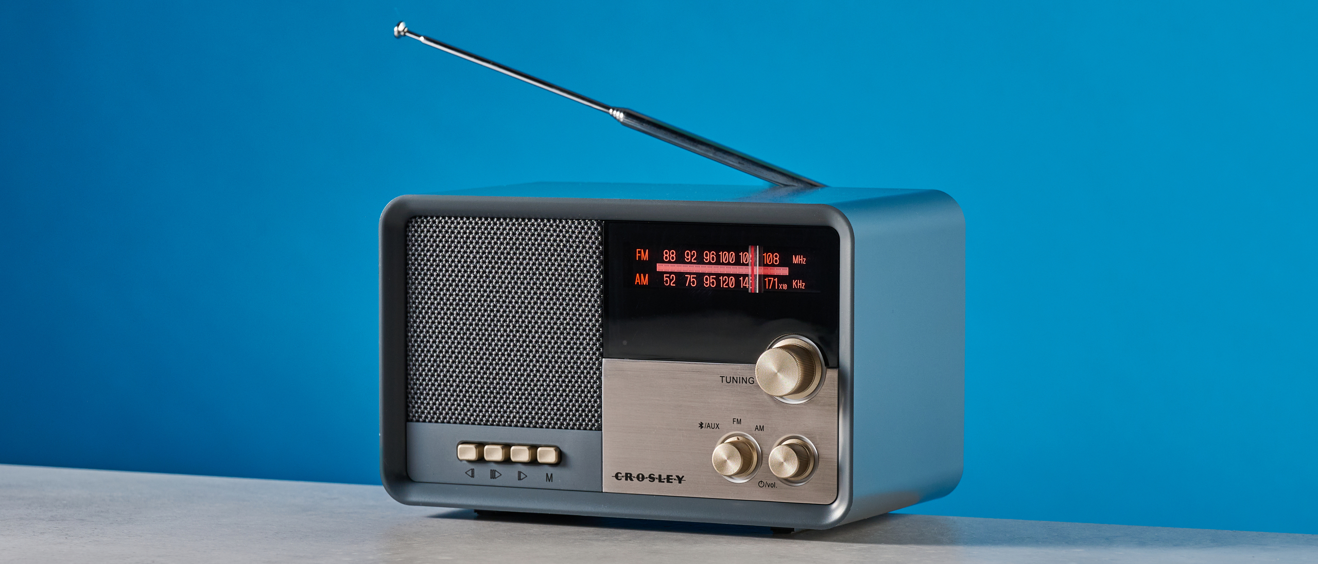 Crosley Tribute Radio in gray color photographed on a blue background