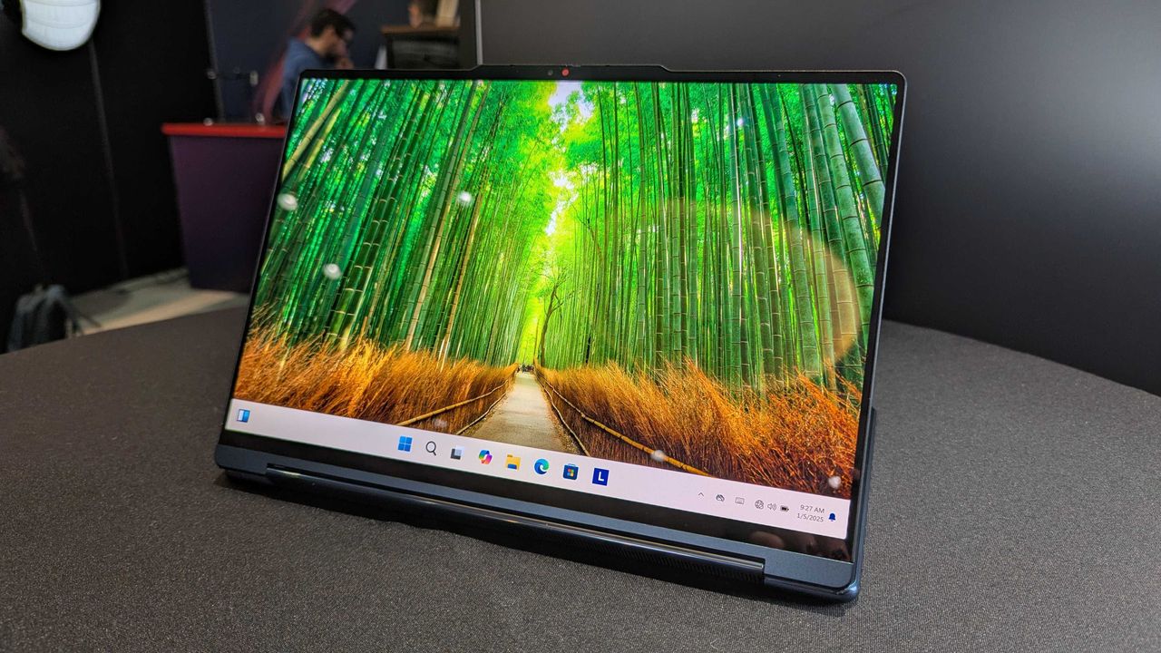 The Lenovo Yoga 9i 2-in-1 14 (Gen 10) Aura Edition on a desk in the "studio" position.