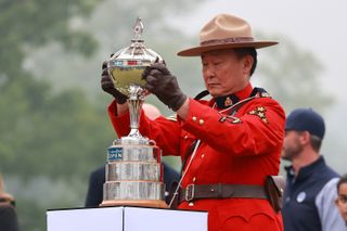 A Royal Canadian Mounted Police officer places the winner's trophy during the award ceremony at the 2024 Canadian Open