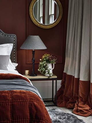 Sumptuous velvet and linen curtains by Neptune in a rust orange bedroom