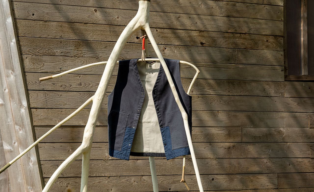 Waistcoat Folk x Architectural Association hanging outdoors on wood