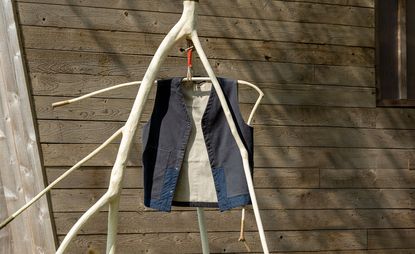 Waistcoat Folk x Architectural Association hanging outdoors on wood