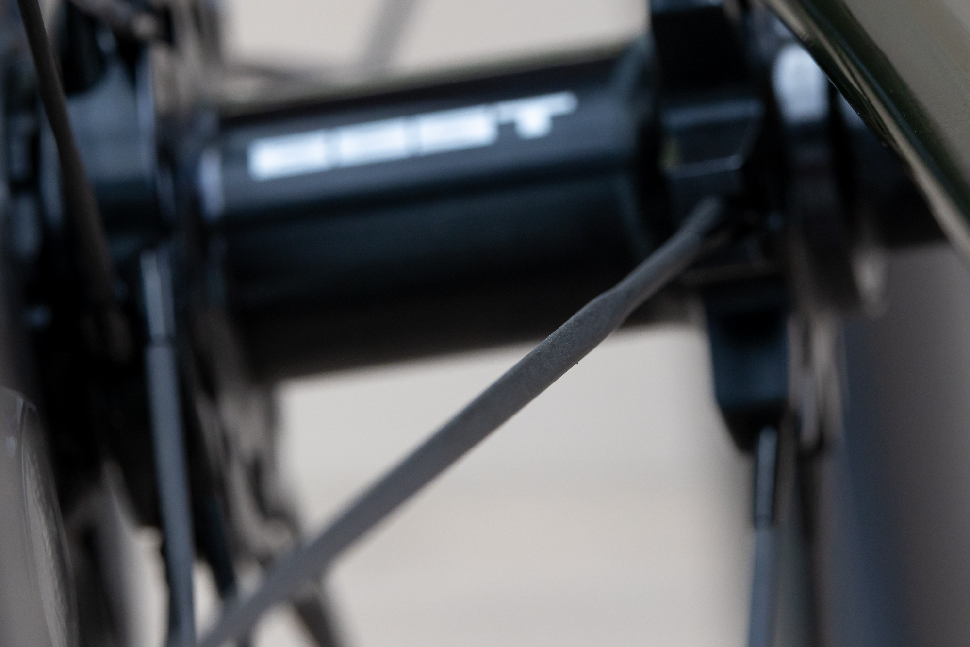 close up of a carbon spoke and front hub