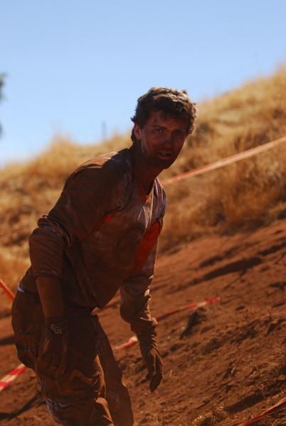 Josh Button ascended from the ground covered in a layer of thick red dust.