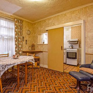 dining room with orange chevron carpet and sliding door