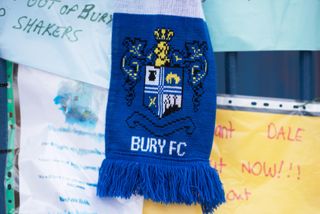 A Bury scarf hangs outside the club's Gigg Lane ground, amid the club's perilous financial situation in August 2019