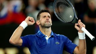 Novak Djokovic of Serbia, brandishing a tennis racket, ahead of Djokovic vs Sinner in the semi-final of the Australian Open 2024 