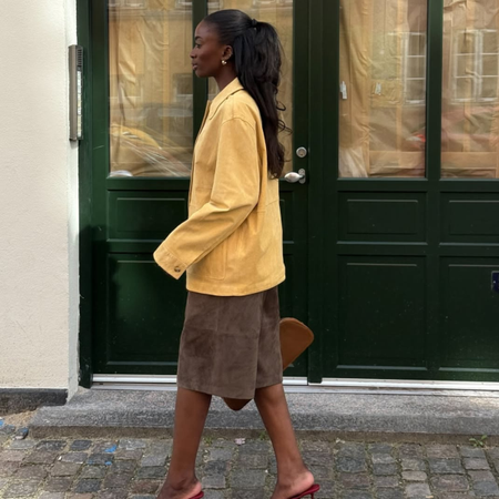 @_livmadeline wears yellow jacket and brown shorts