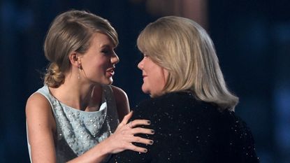 Taylor Swift embraces her mother on stage.