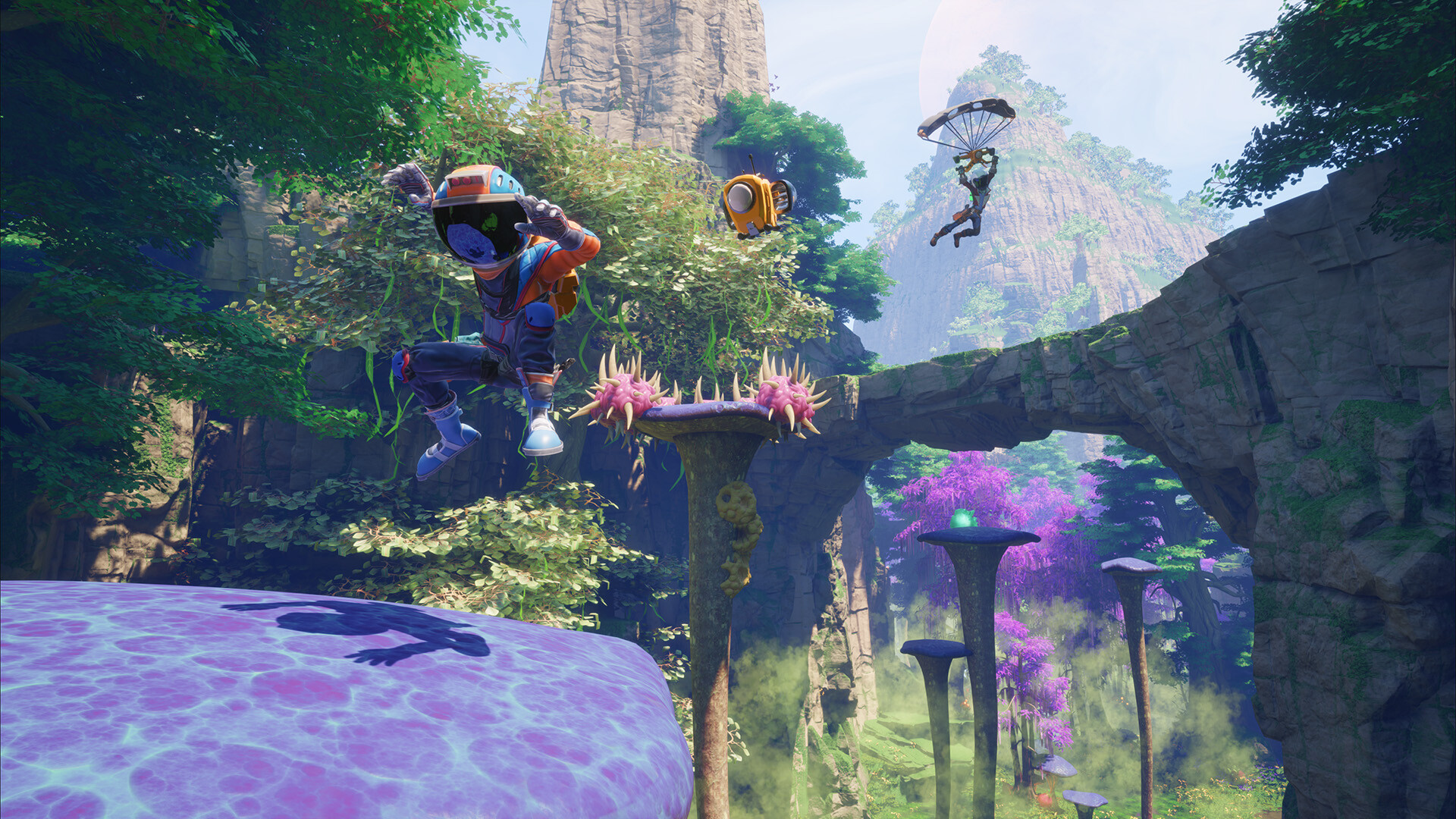 One player jumps onto a large bouncy purple mushroom in Revenge of the Savage Planet as another uses a glider in the distance