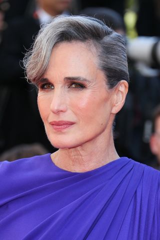 Andie Macdowell is pictured with her grey hair in an updo at the Red Carpet of the closing ceremony at the 77th annual Cannes Film Festival at Palais des Festivals on May 24, 2024 in Cannes, France.