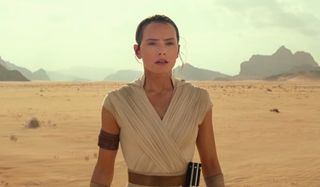 Star Wars: The Rise of Skywalker Rey stands in the desert, with a lightsaber on her belt