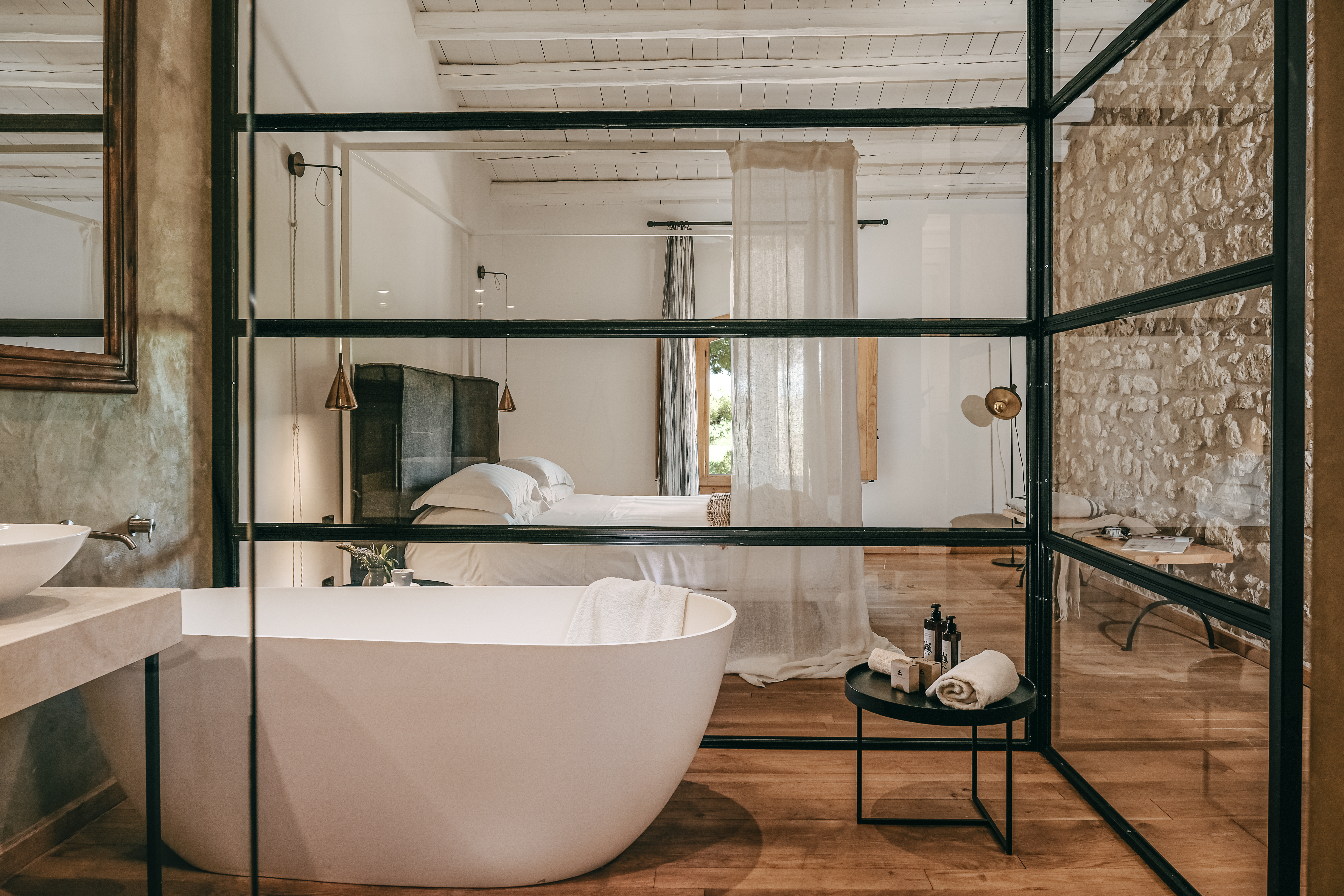 A modern farmhouse immersed in the goldeny vegetation of Sicily at the peak of summer pairs sprawling vegetation with a rustic-chic interior look.