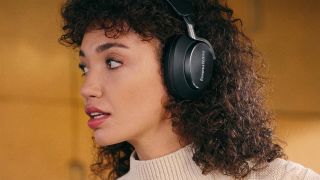 Bowers & Wilkins Px8: Woman listening to music on a pair of Bowers & Wilkins Px8 headphones