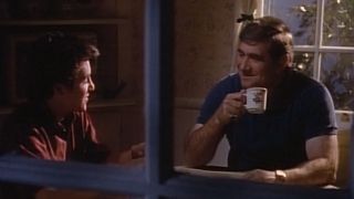 Fred Savage and Dan Lauria sit smiling at the kitchen table in The Wonder Years series finale.