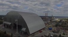 A huge metal arch, called the new confinement shelter, is being slid into place over Chernobyl's destroyed reactor 4.