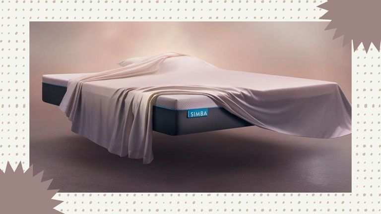 image of the Simba Hybrid mattress—one of the products in the current Simba mattress sales—with a blanket draped over it on a dotty beige background