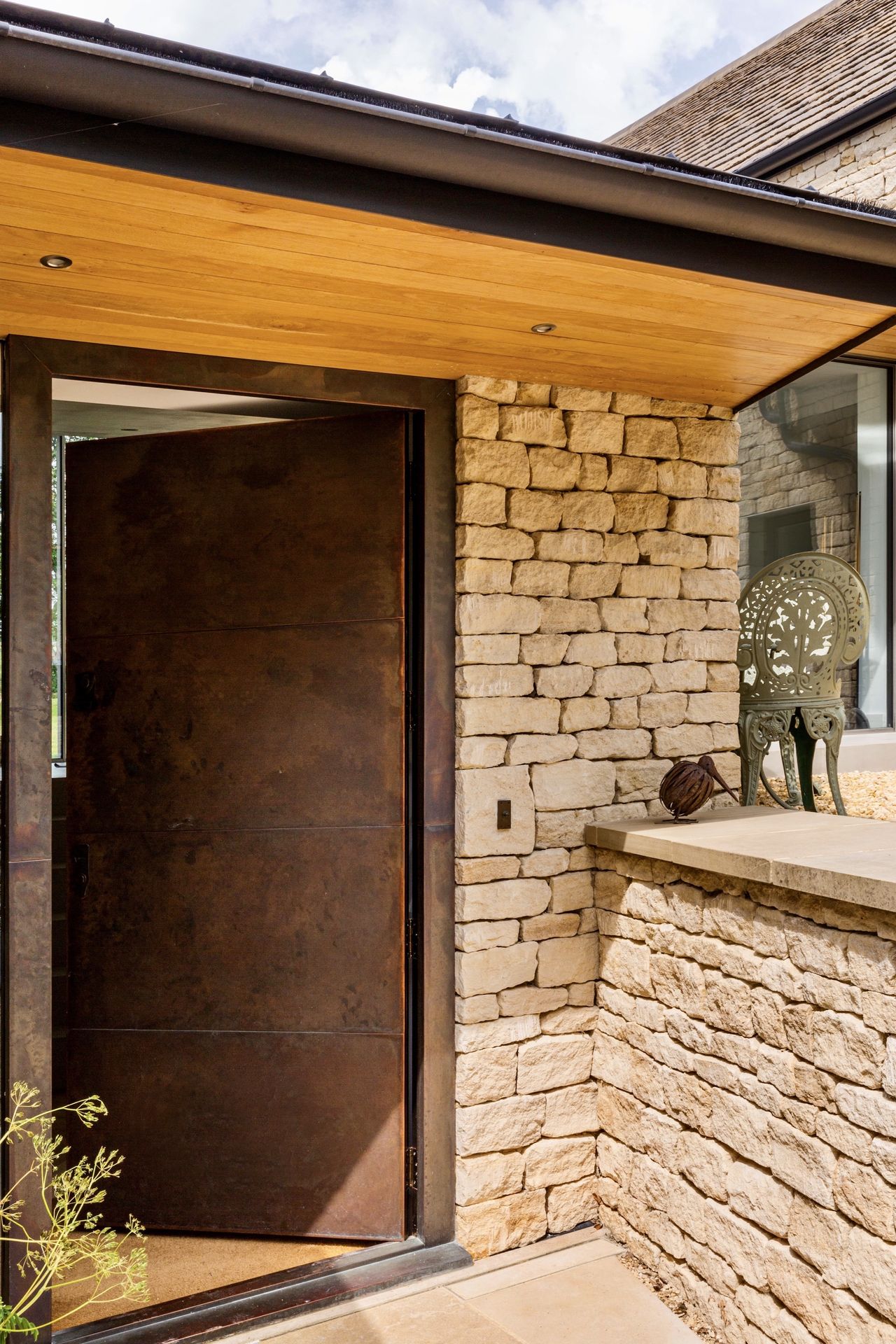 metal front door to stone house