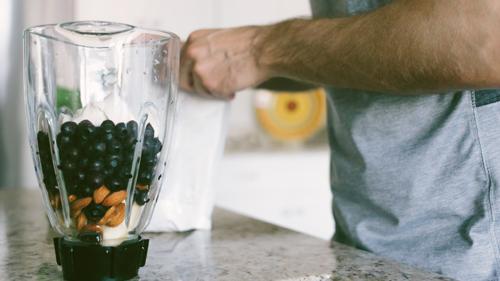 man preparing a healthy smoothie post-workout