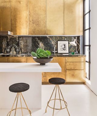 Modern kitchen with gold cabinetry and white countertop