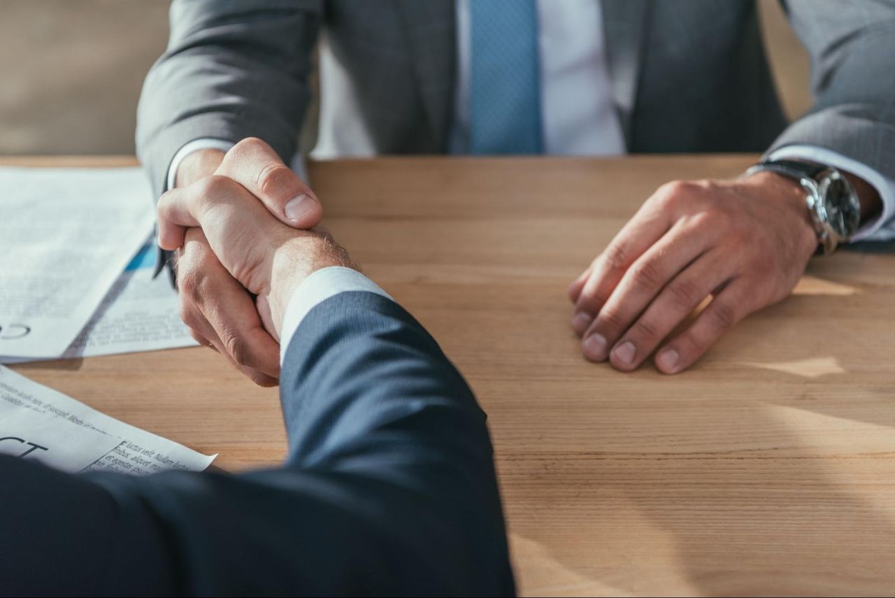 Two white businessmen shaking hands