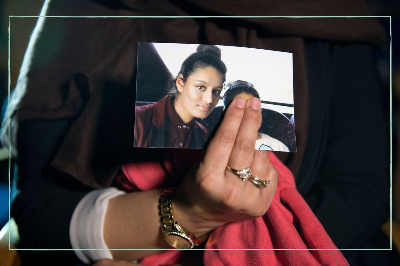 An unidentified woman holding a photograph of Shamima Begum before she left for Syria