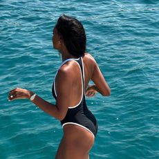Jasmine Tookes wearing a one-piece swimsuit