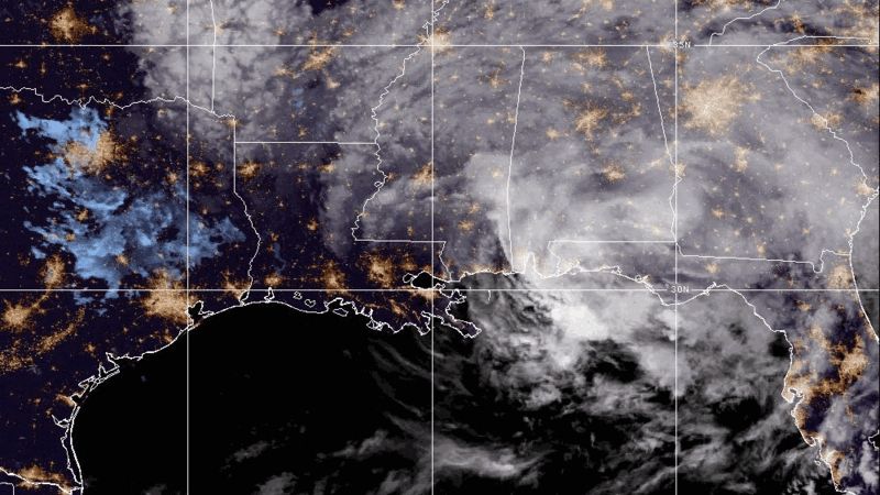 A large swirl of white clouded hurricane rests over a dark map of the southern united states.