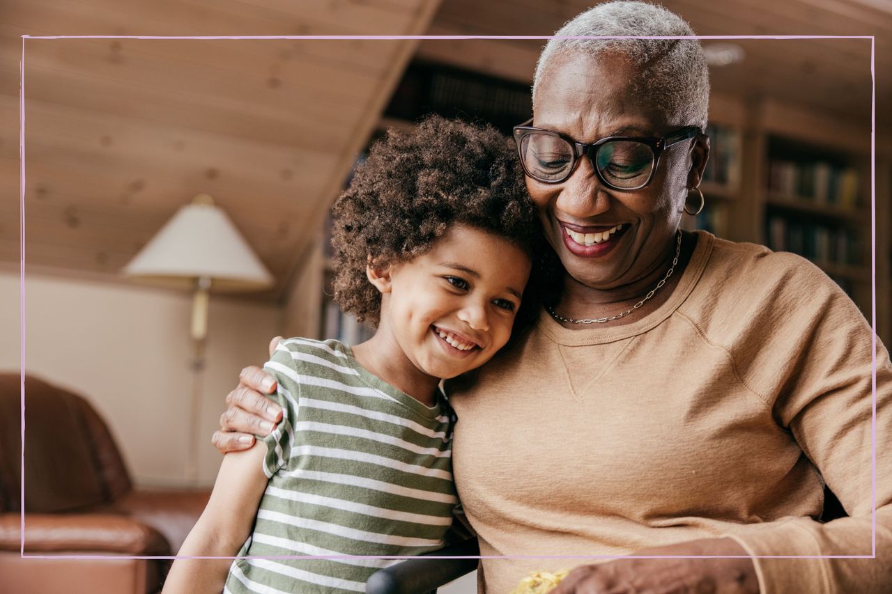 A smiling grandmother with her arm around a young girl