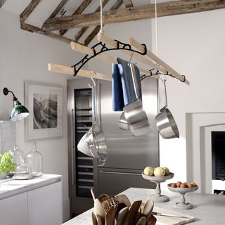 rustic kitchen with an Edwardian style over head hanging pan rack