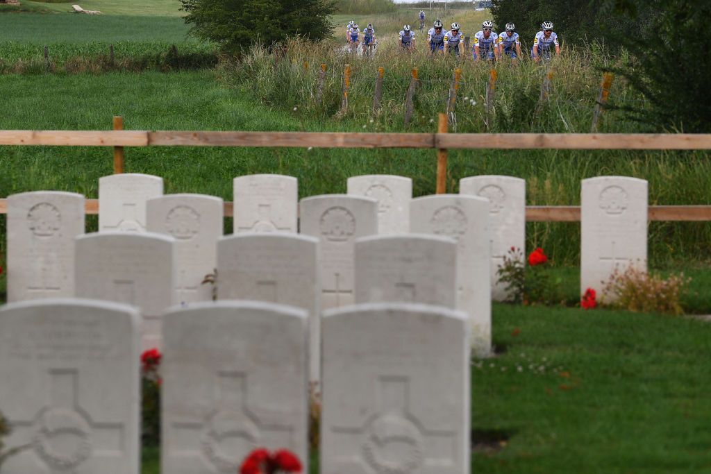 The Deceuninck-QuickStep riders pass a war cemetery