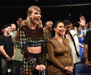 Singer-songwriter Taylor Swift and TV personality Kim Kardashian in the audience during the 2015 MTV Video Music Awards at Microsoft Theater on August 30, 2015 in Los Angeles, California
