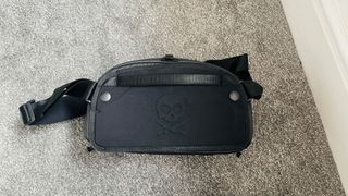 A GoMatic McKinnon Camera Sling 8L lying on a carpet