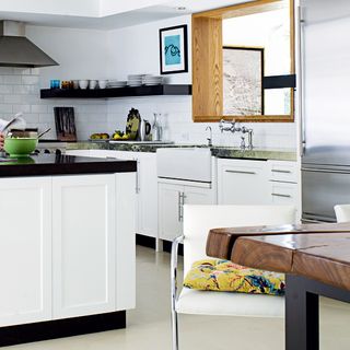kitchen with white wall black counter and white cabinet