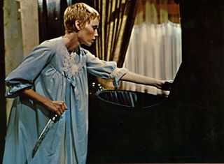 mia farrow in a nightgown holding a knife over a baby carrier in Rosemary's Baby