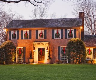 Home exterior with Christmas lights and wreaths