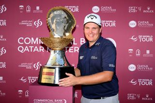 Sami Valimaki poses next to the Qatar Masters trophy