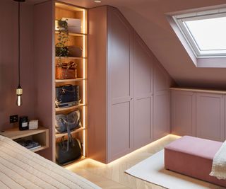 pink bedroom storage with illuminated shelving and herringbone wooden floor