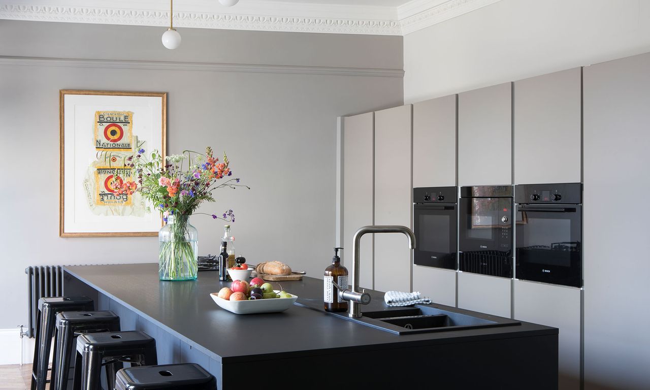 kitchen room with grey countertop and stools