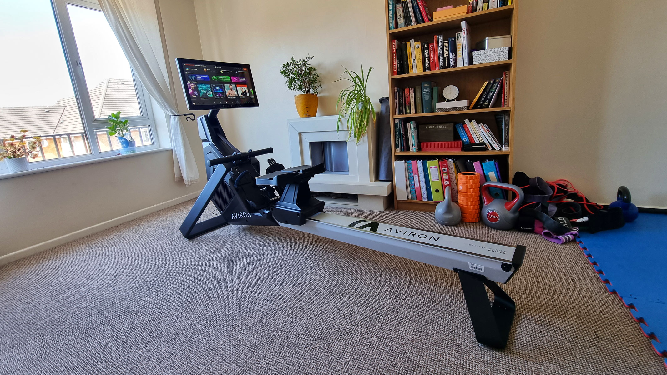 The Aviron Strong Series Rower standing in the living room