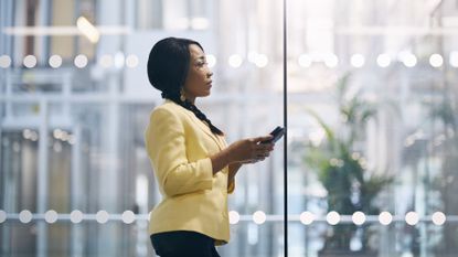 Woman On Phone In Office Looking Tired