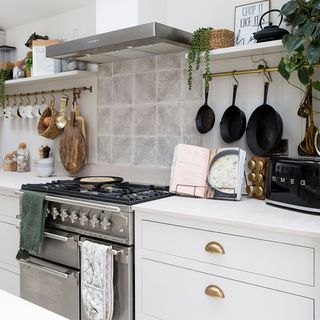 white kitchen with cabinets and range cooker